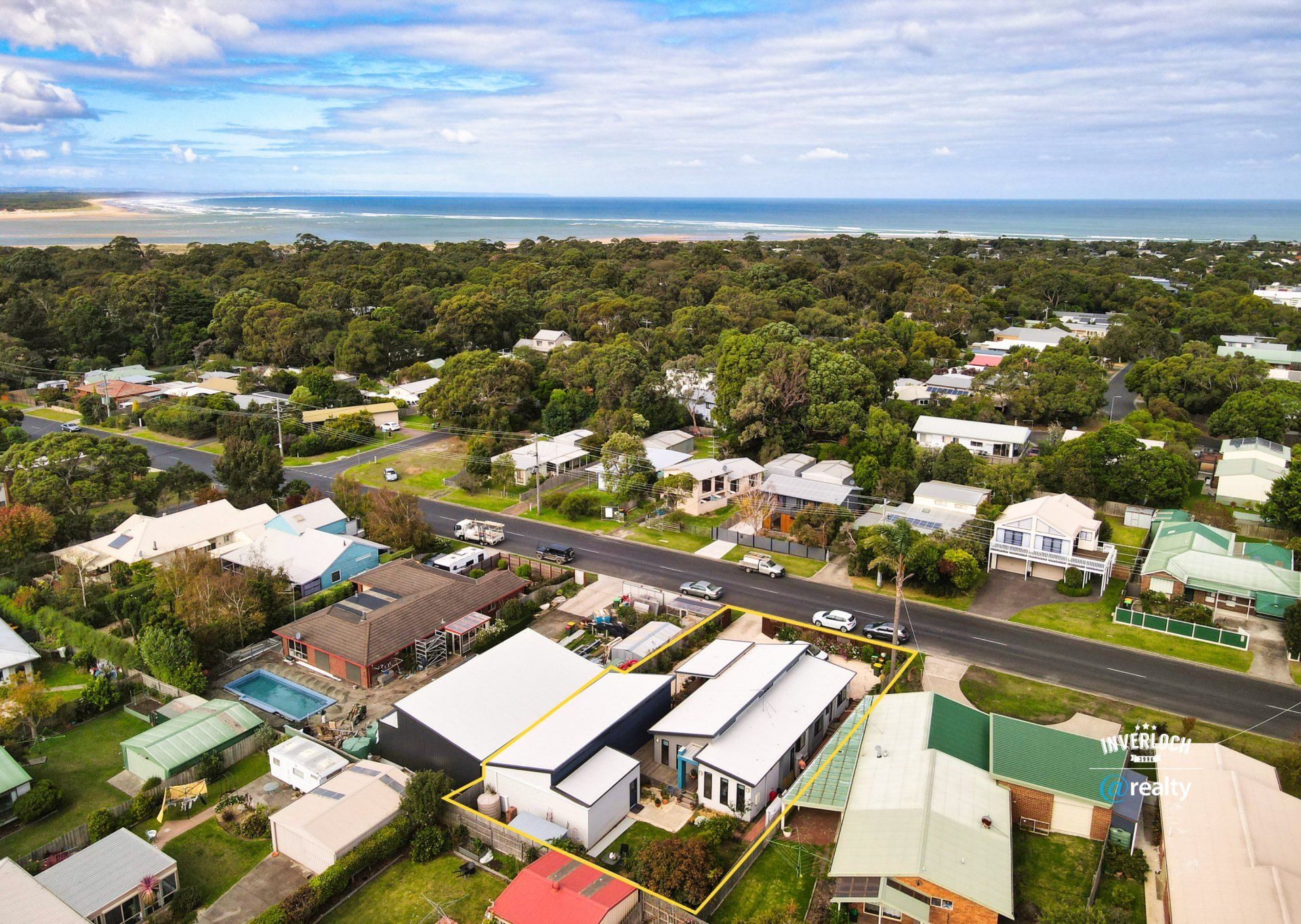 An aerial view of a residential area next to the ocean.