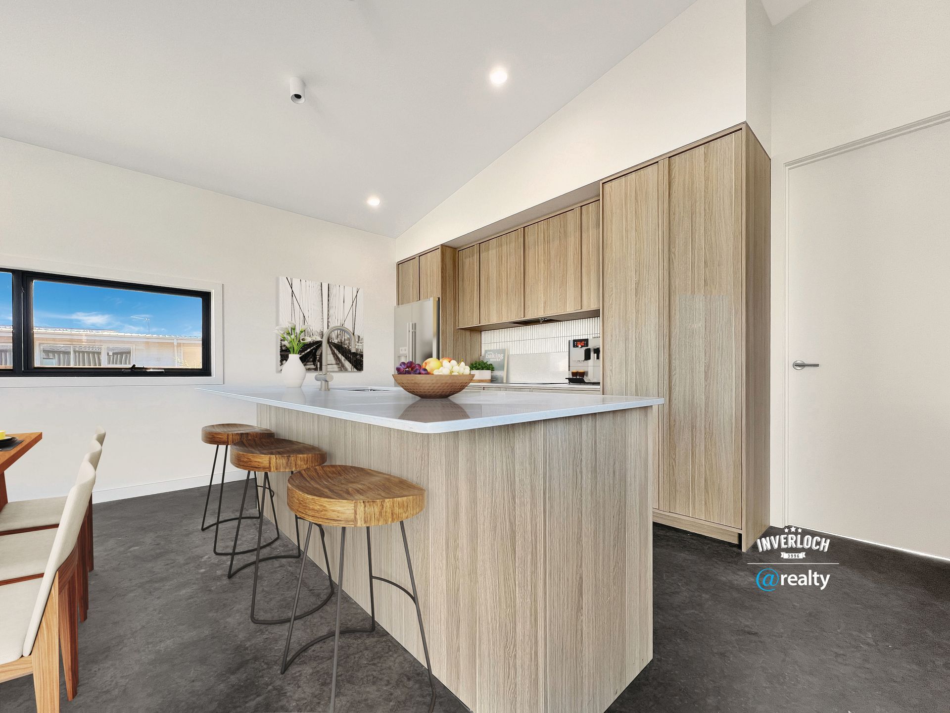 An artist 's impression of a kitchen with a large island and stools.