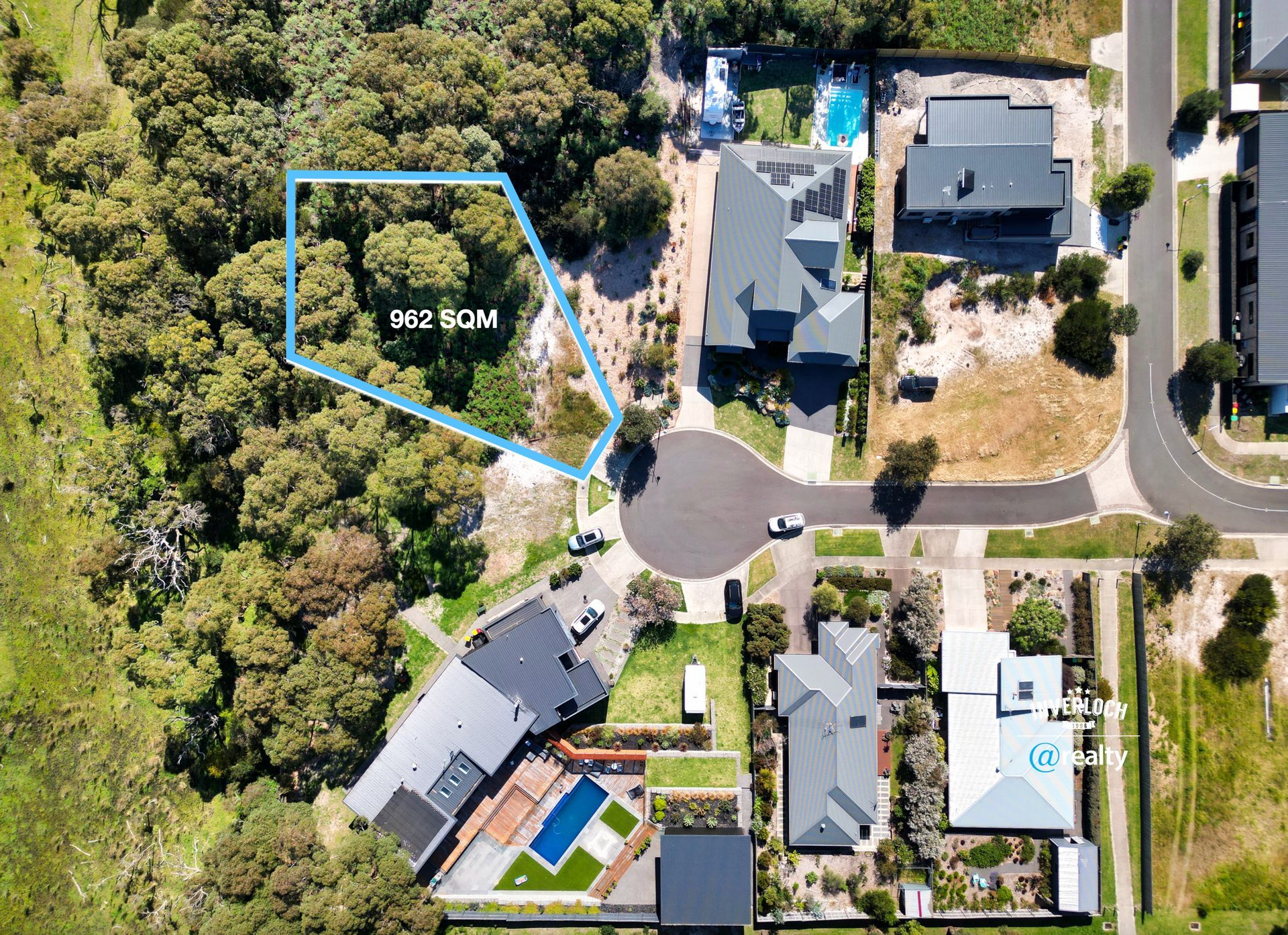 An aerial view of a residential area with houses and trees