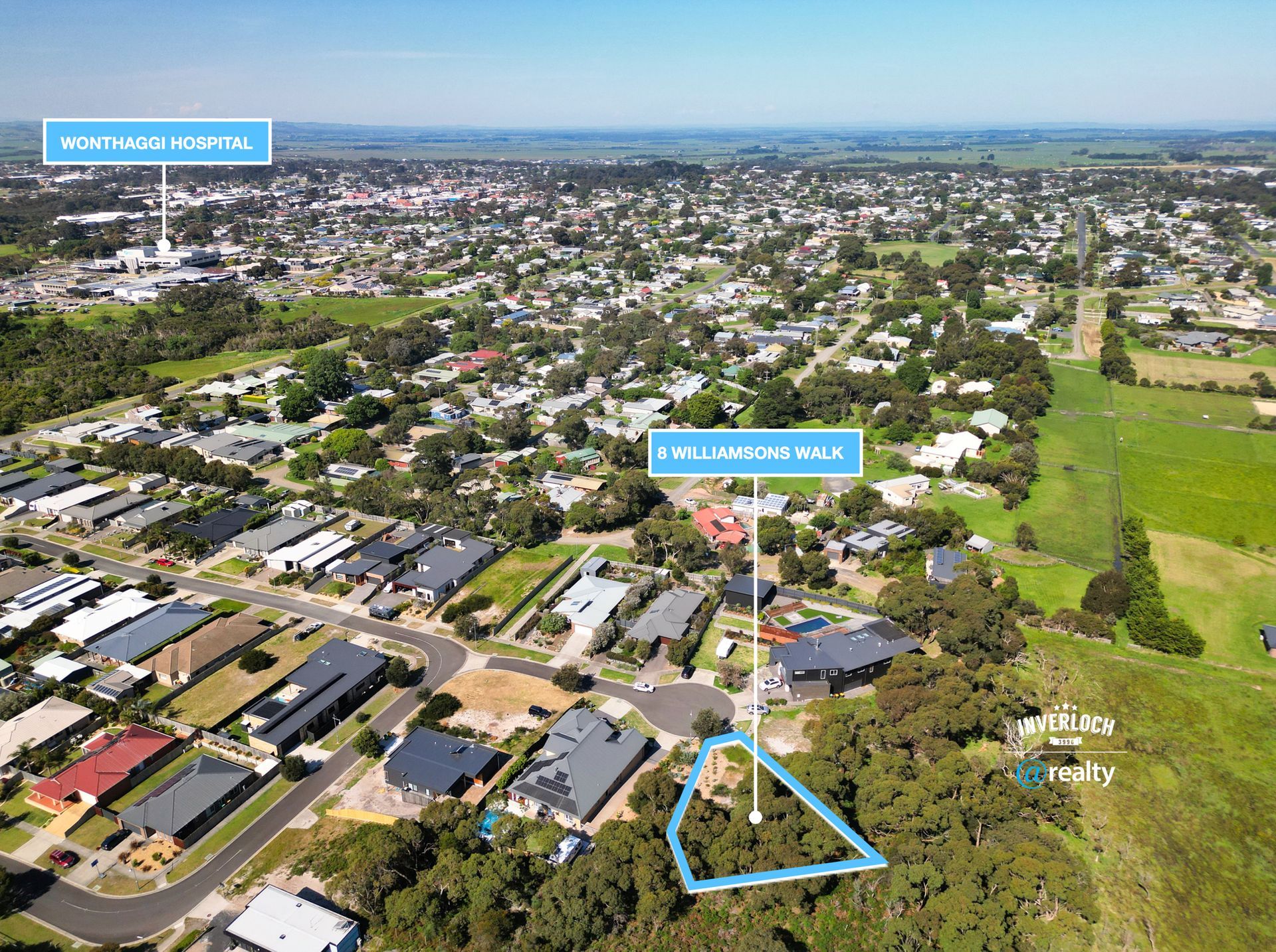 An aerial view of a residential area with a lot of houses and trees.