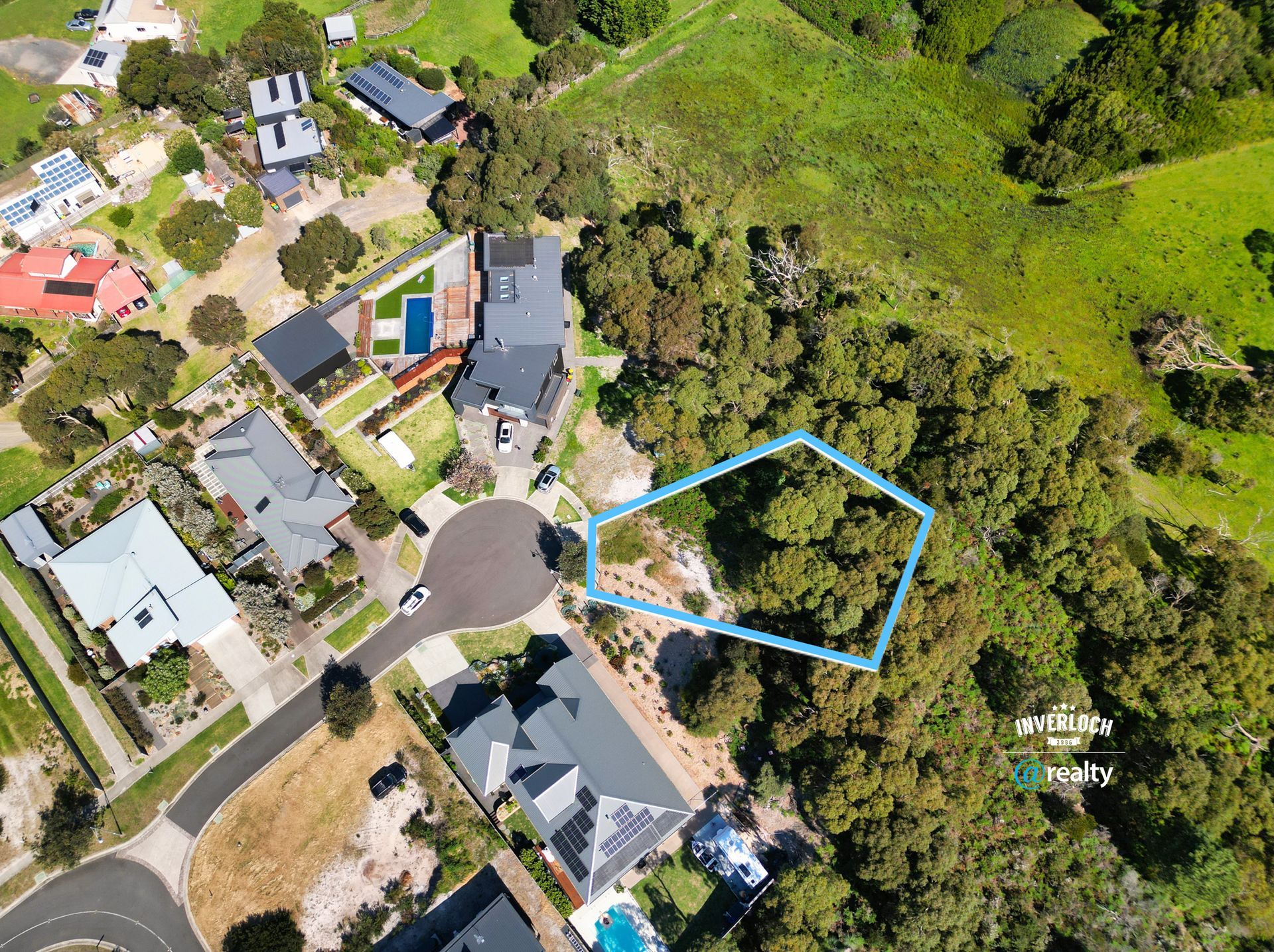 An aerial view of a residential area with houses and trees