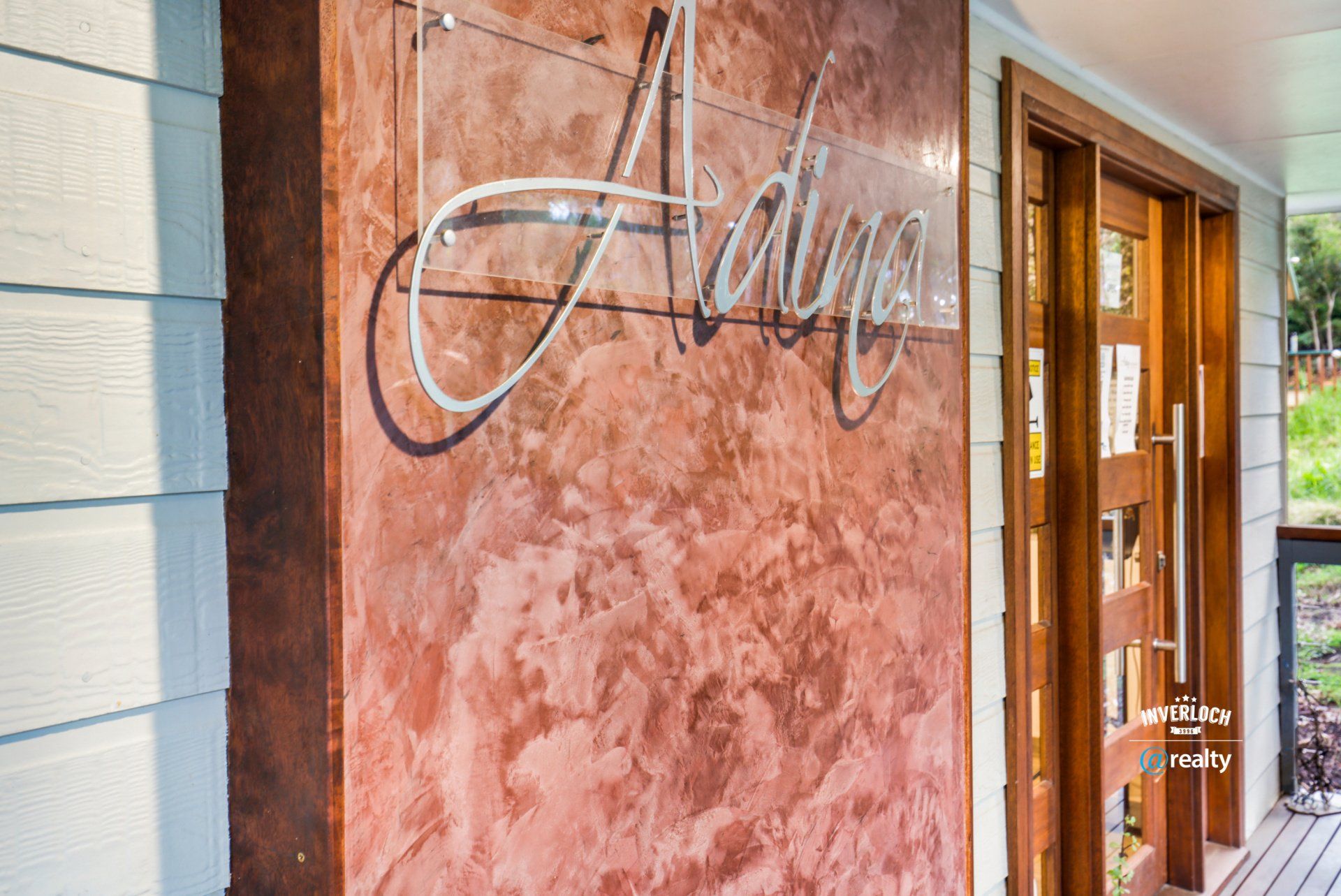 A red wall with the word adina written on it