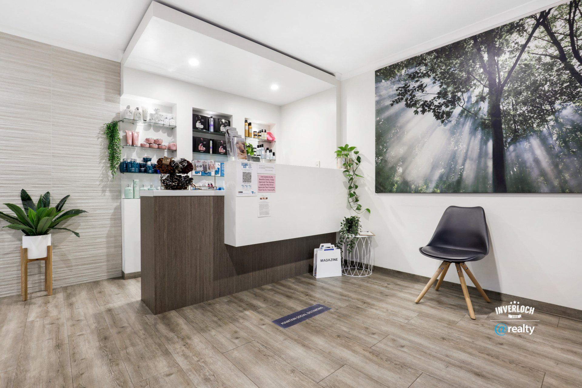 A waiting room with a reception desk and a chair.