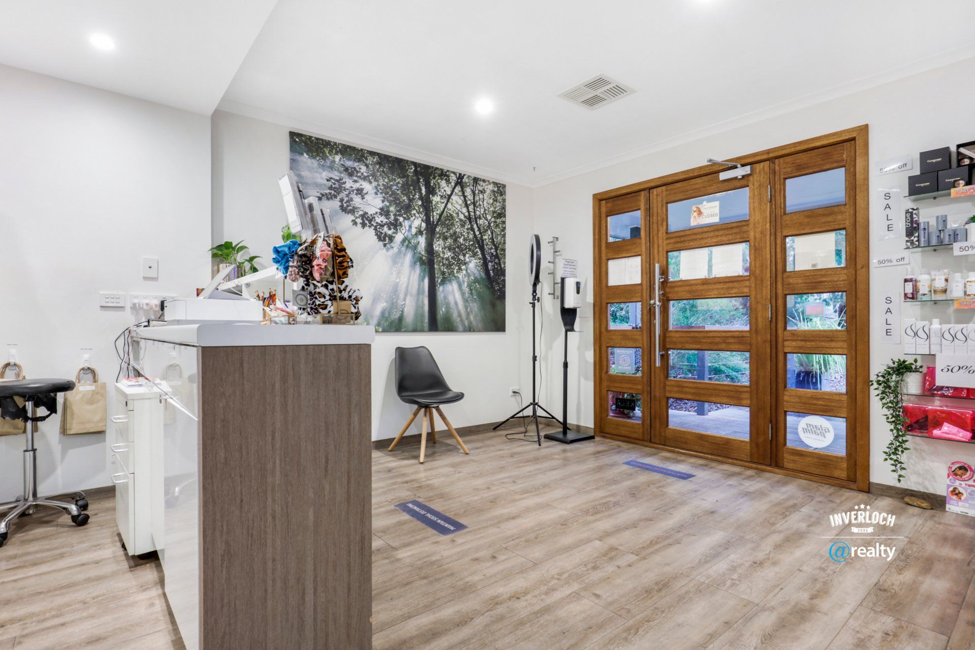 A salon with a wooden floor and a wooden door.