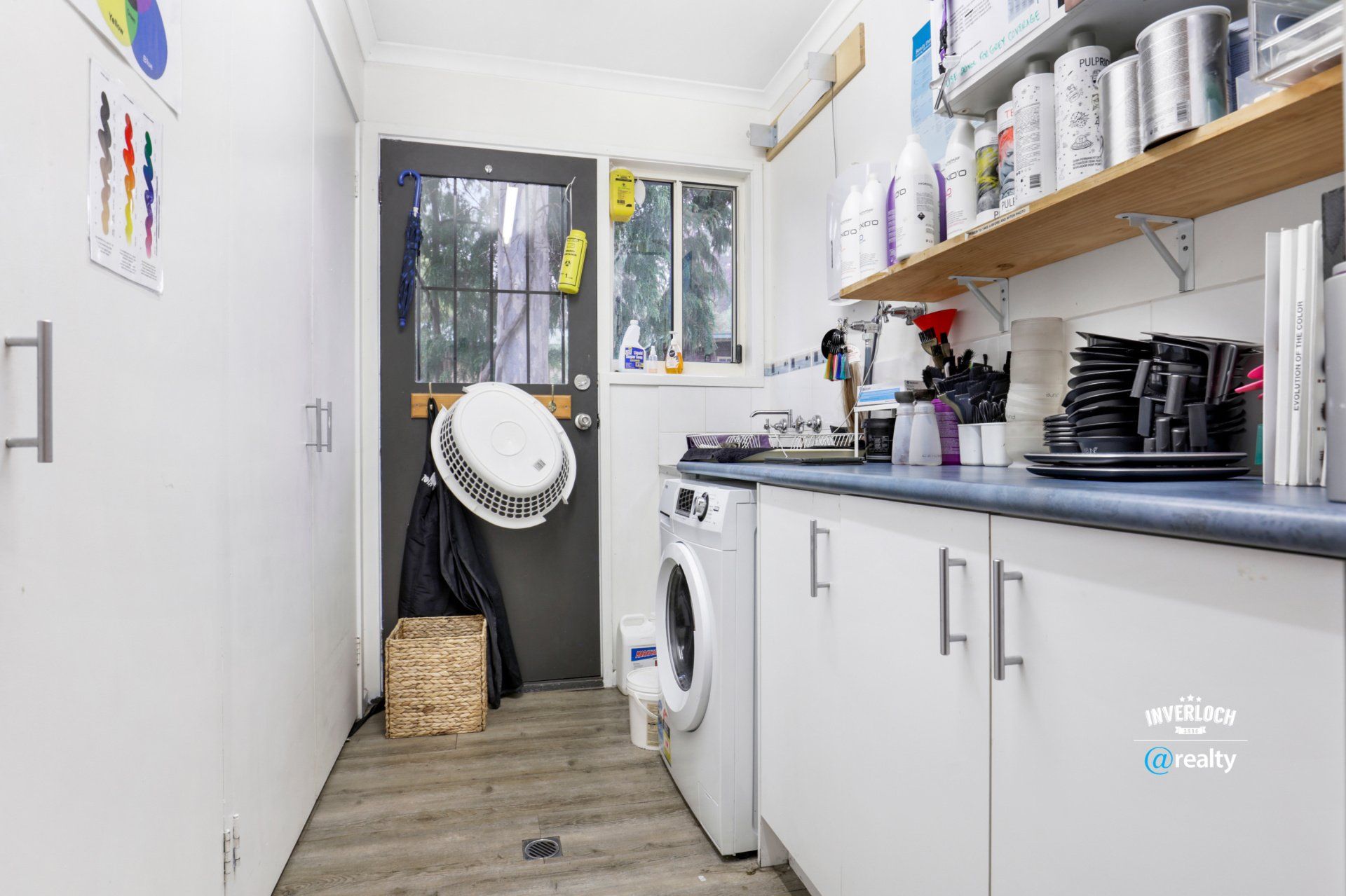 A laundry room with a washer and dryer and a sink.