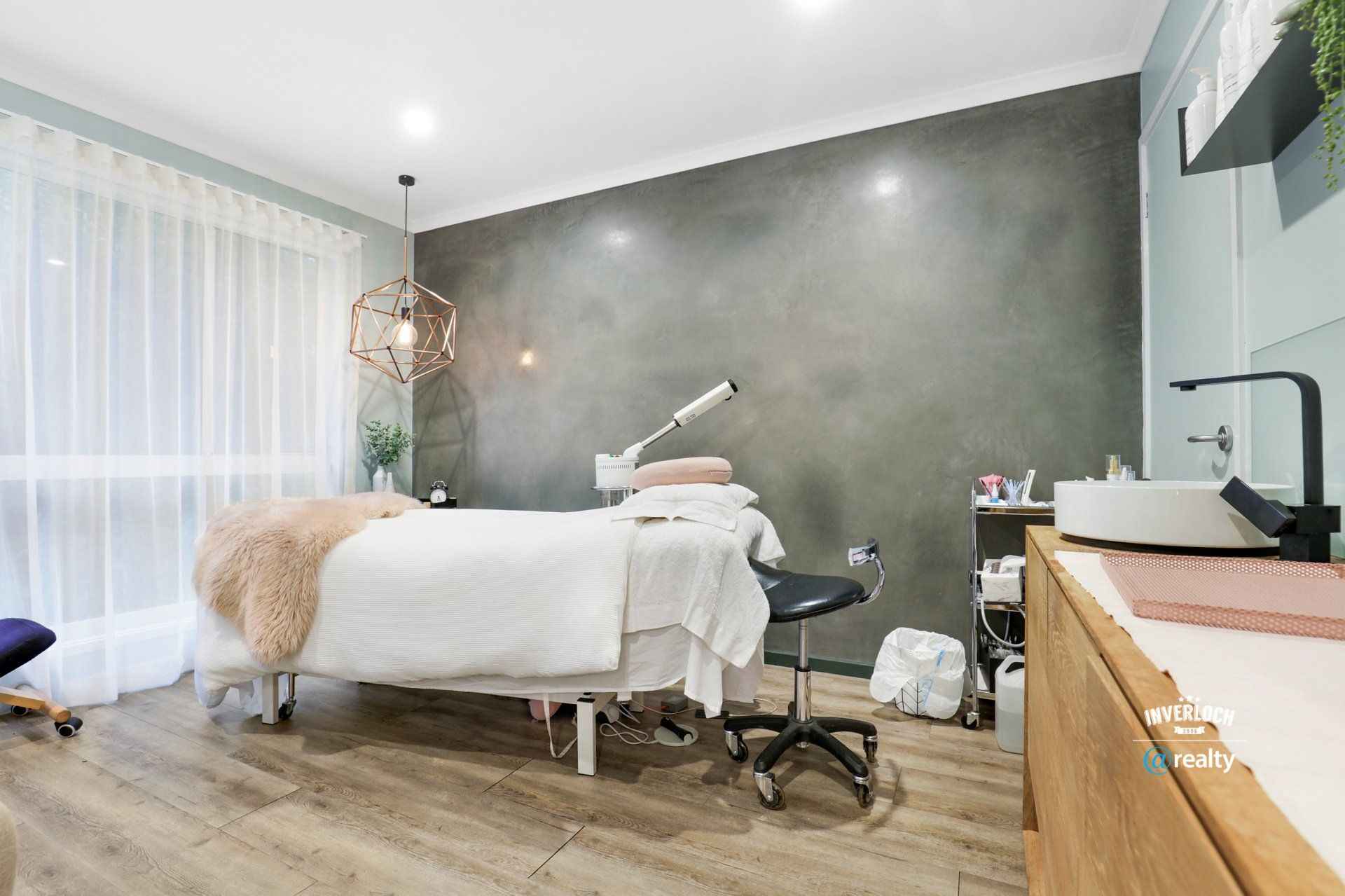 There is a massage table in the middle of the room.
