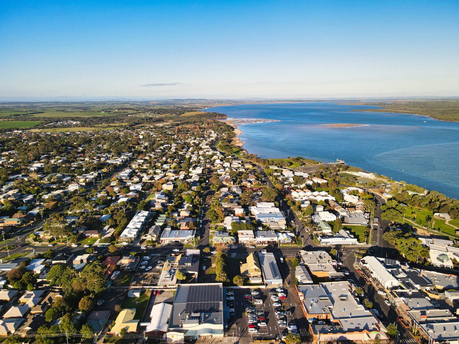 An aerial view of a city next to a body of water.