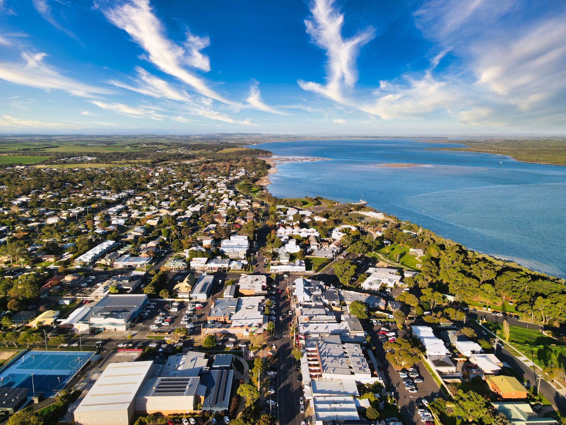 An aerial view of a city next to a body of water.