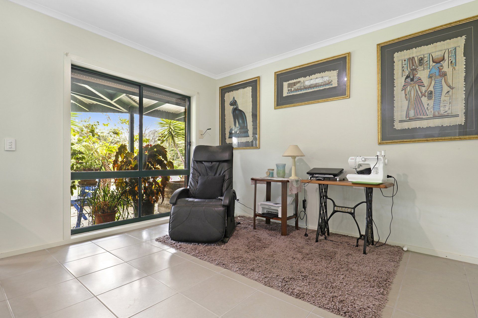 A living room with a chair and a sewing machine