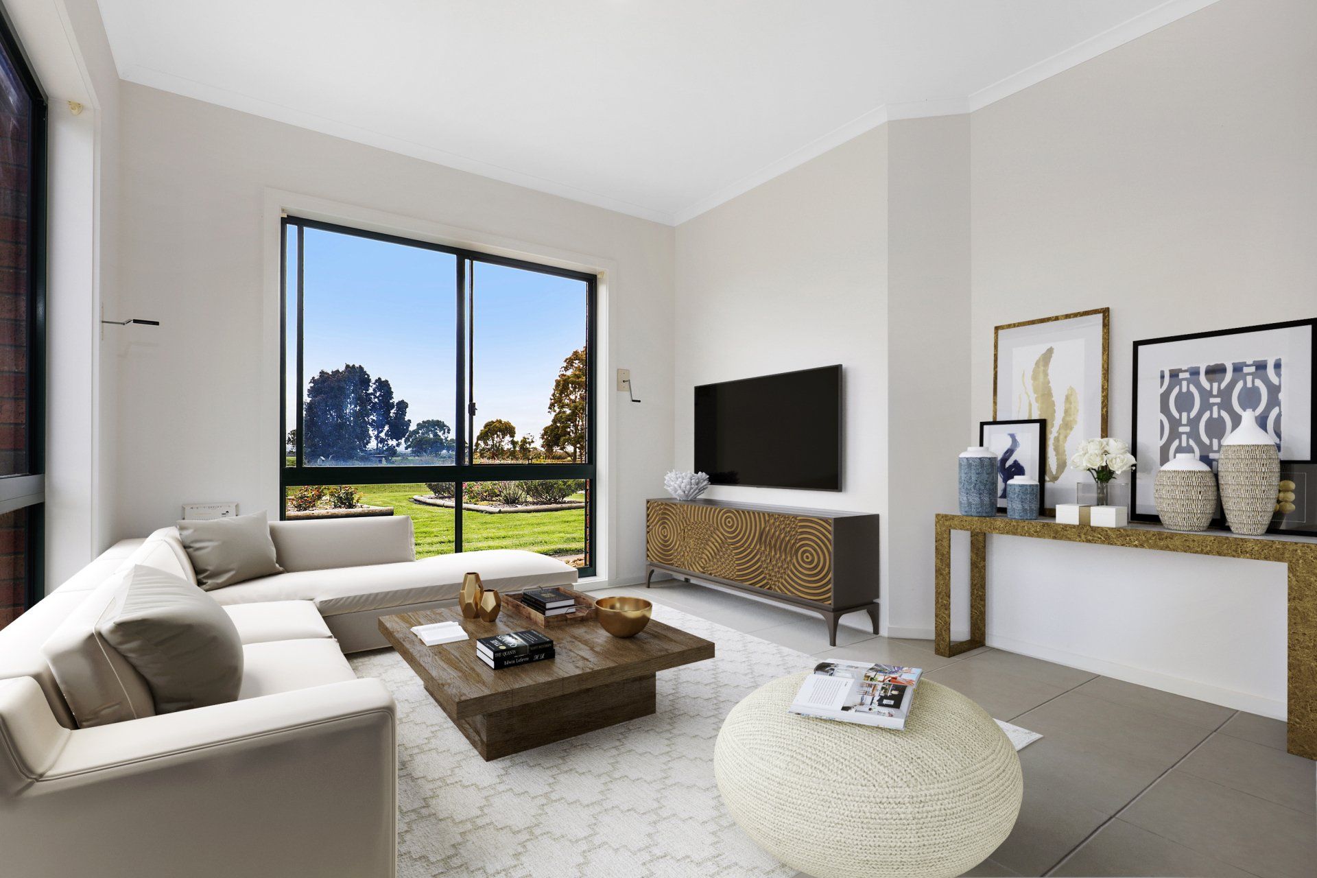 A living room with a couch , coffee table , and television.