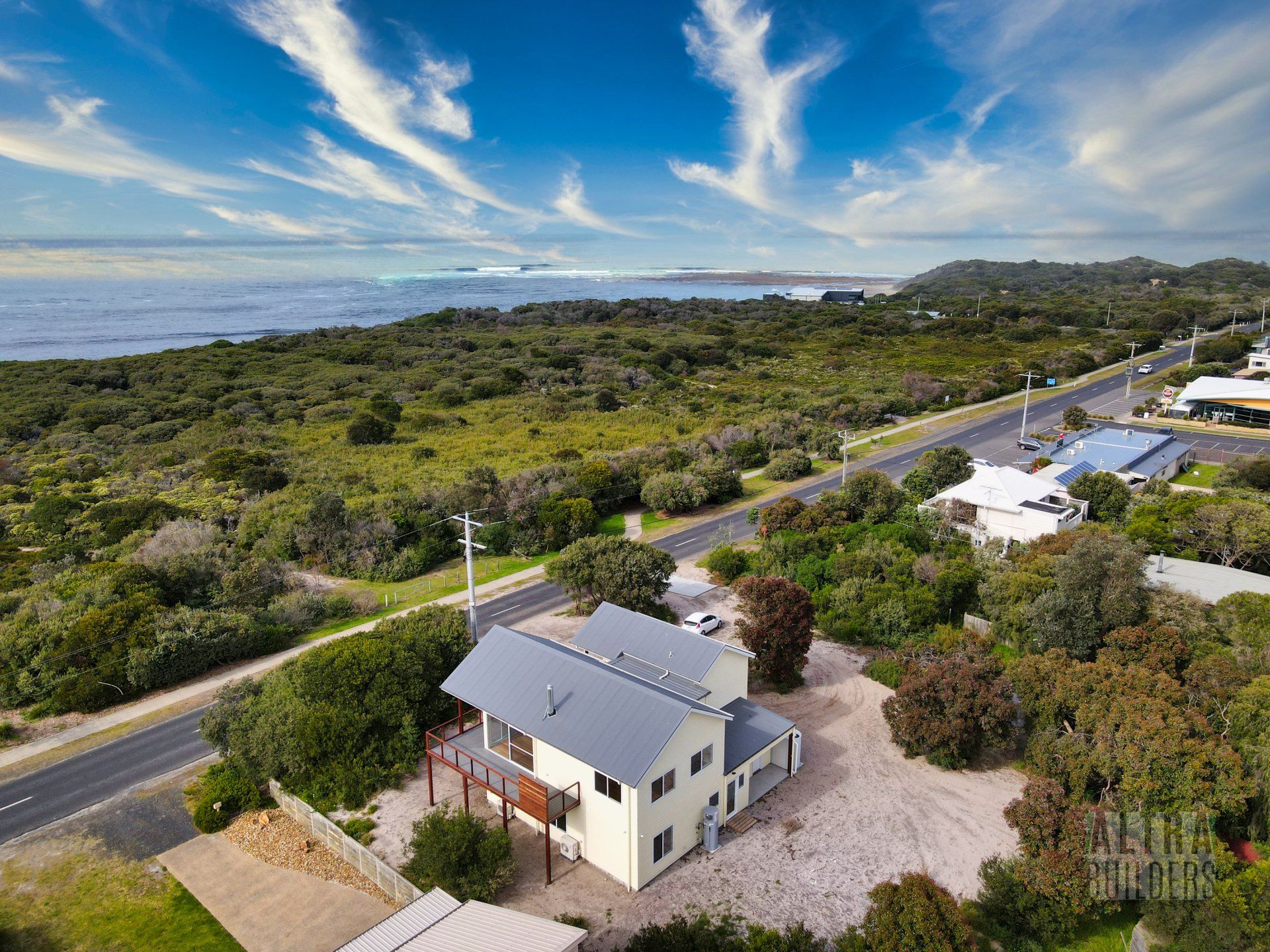 An aerial view of a house with a view of the ocean.