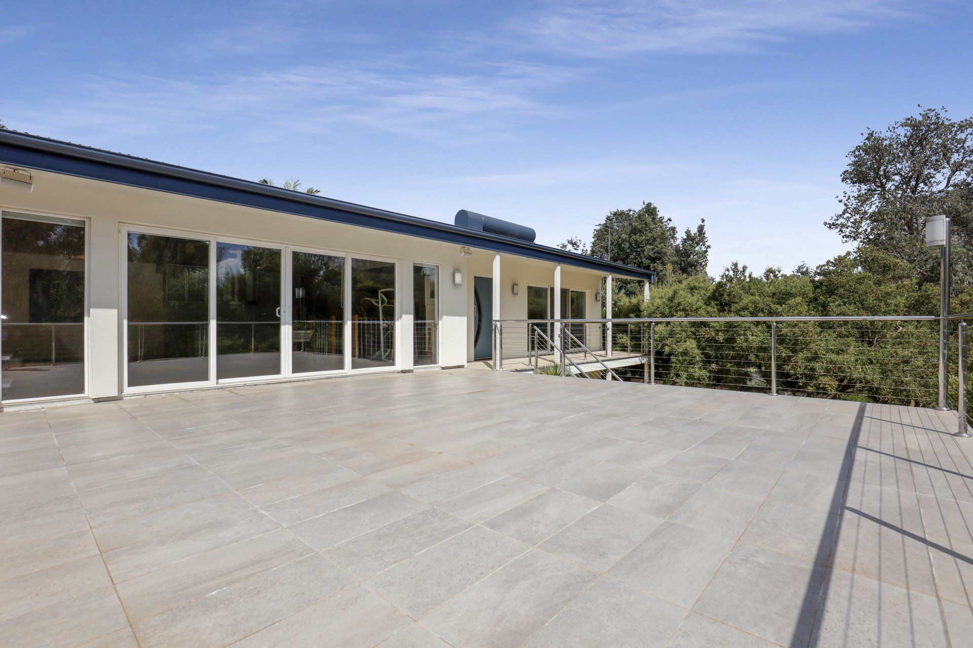 A large house with a large deck in front of it.