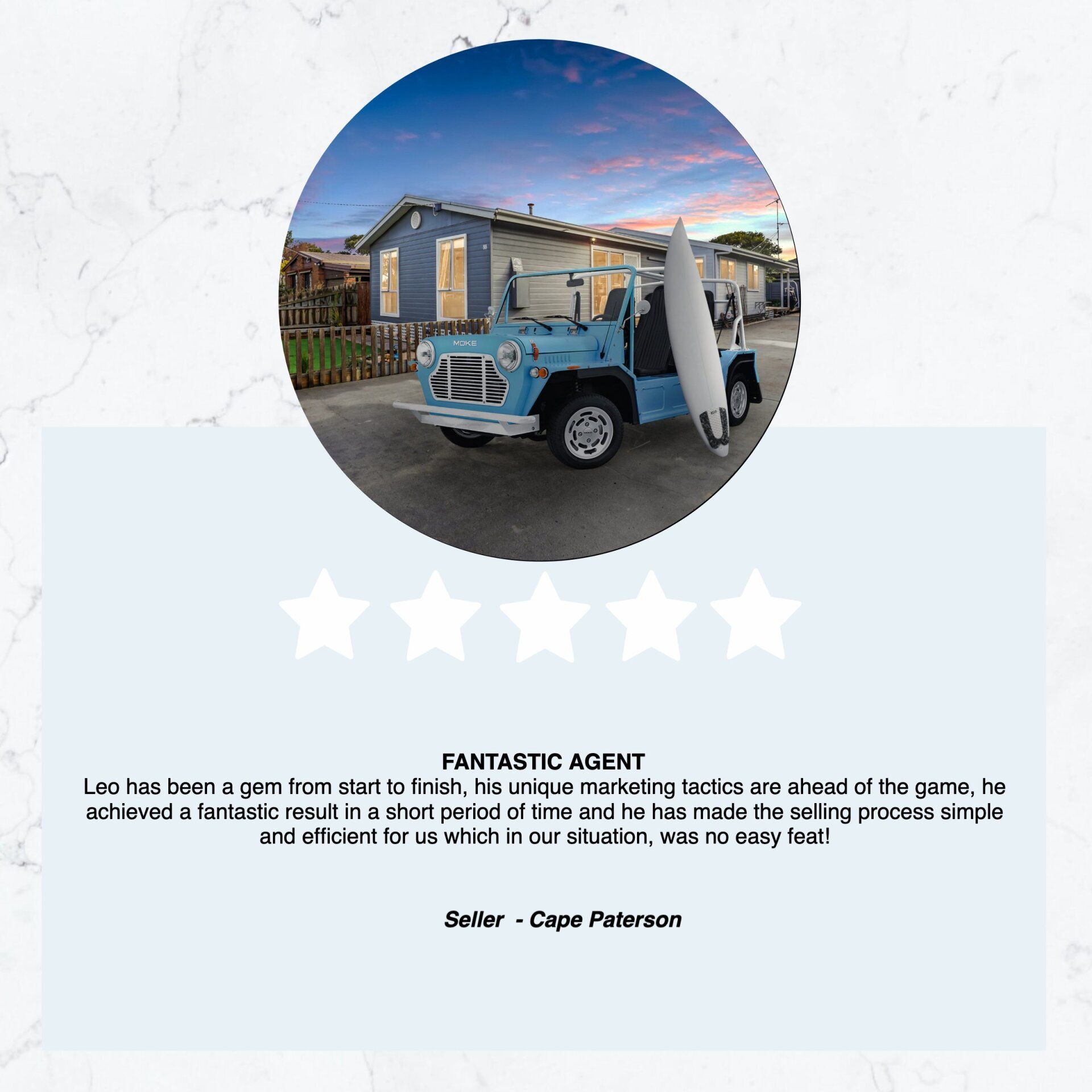 A blue truck with a surfboard in the back is parked in front of a house.