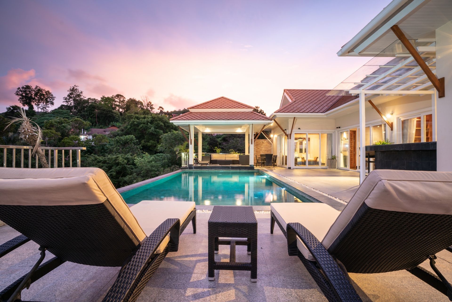 A large house with a swimming pool in front of it
