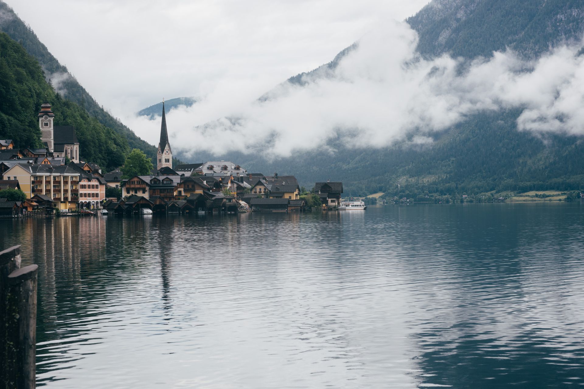 A small town is surrounded by mountains and a lake.