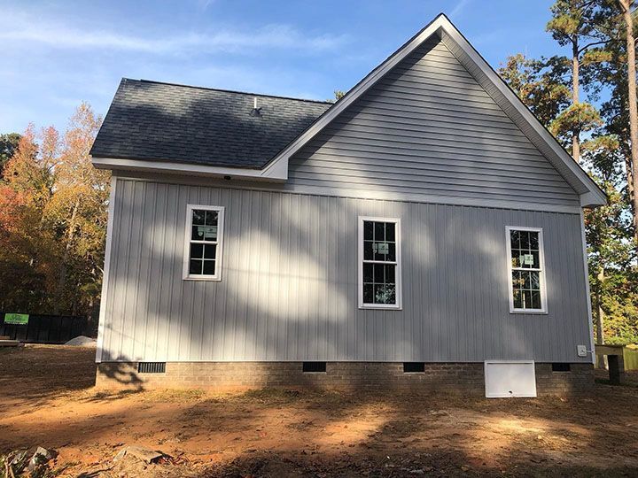 Custom home framing and vertical siding installation during a build-on-your-lot project in Chatham County NC