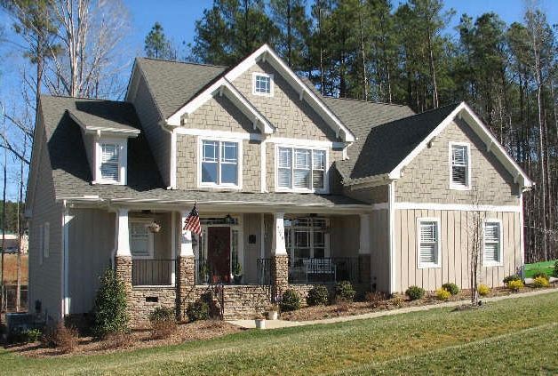 Custom craftsman home with board and batten siding and stone column porch built in Fuquay-Varina NC