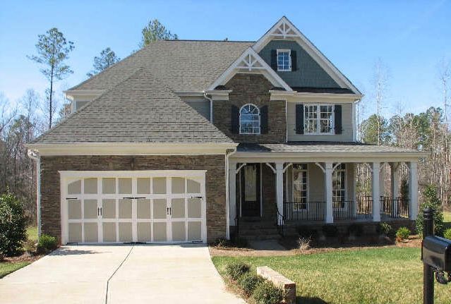 Two-story craftsman home exterior featuring front porch and stone accents in Fuquay-Varina NC