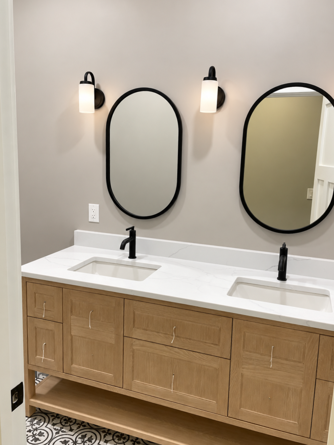 Modern bathroom with white bathtub, tiled shower wall, and partial toilet visible by the window
