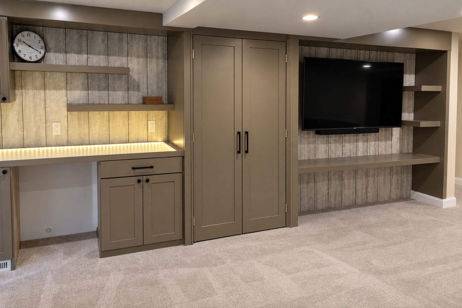 Modern built-in kitchenette and TV cabinet in a light wood-paneled room