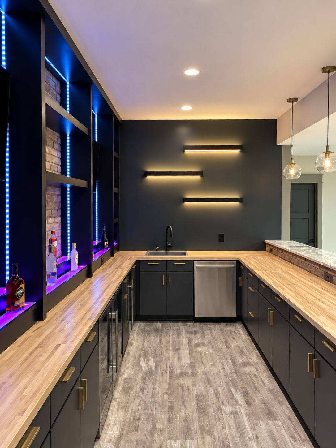 Modern galley kitchen with dark cabinets, light wood countertops, and purple accent lighting