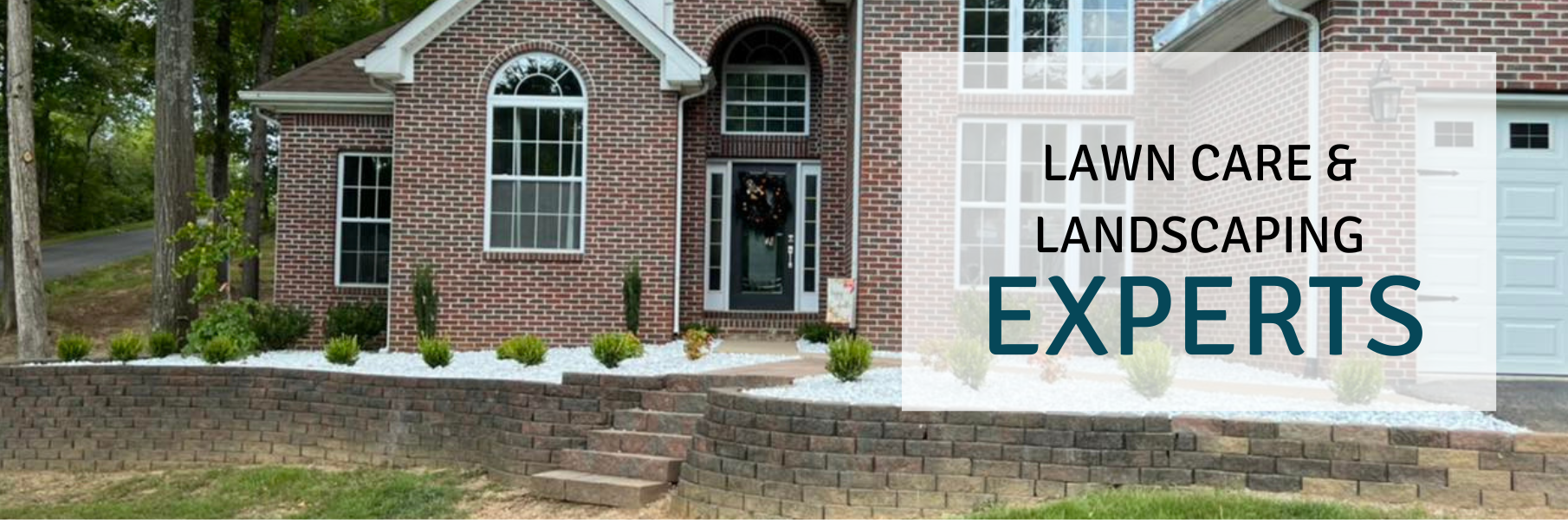Landscaped brick house with lawn care and landscaping experts sign in the yard