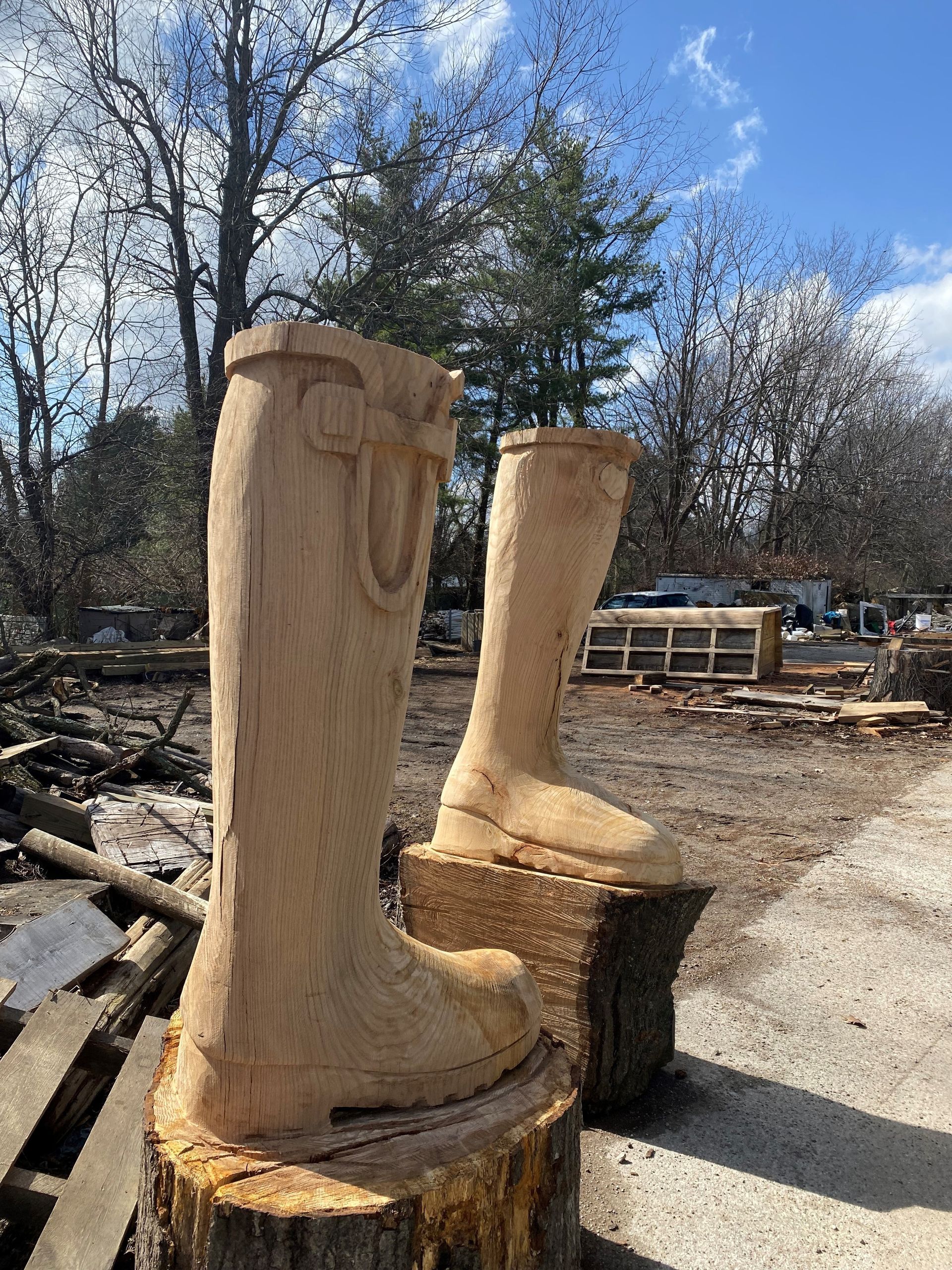 A pair of wooden boots carved into a tree stump.
