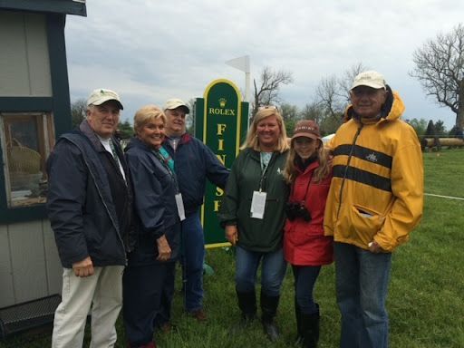 A group of people standing in front of a sign that says finish