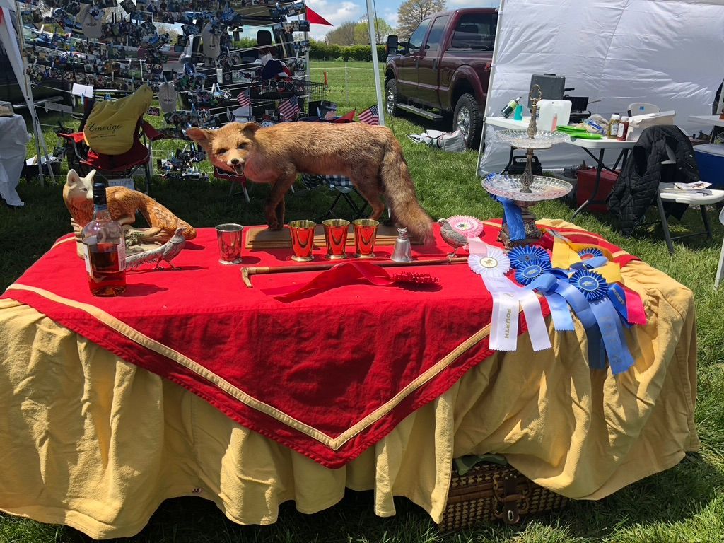 A table with a red tablecloth and a stuffed animal on it.