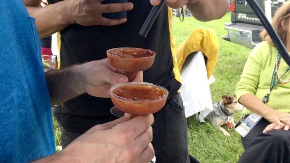 A group of people are holding glasses of drinks in their hands