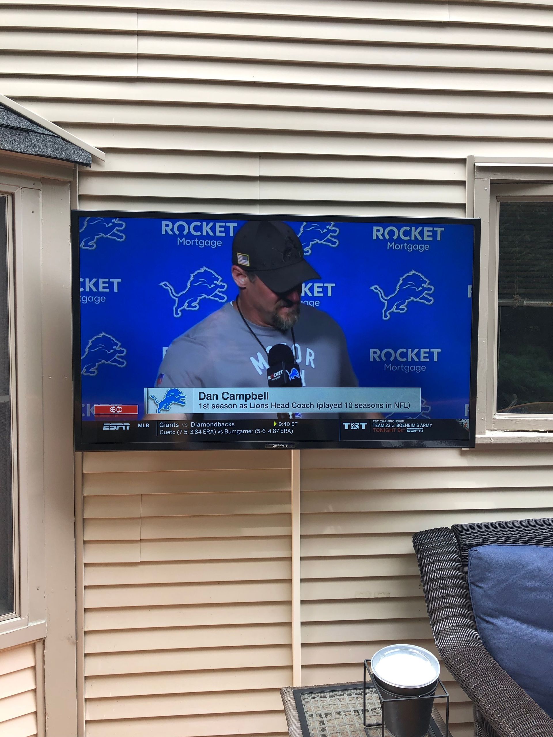 TV showing a baseball pitcher interview on a blue Rocket-branded backdrop outdoors by Audio Video Concepts