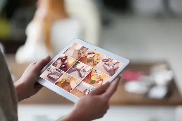 Hands holding a tablet showing a photo gallery of coffee and dessert images  byAudio Video Concepts