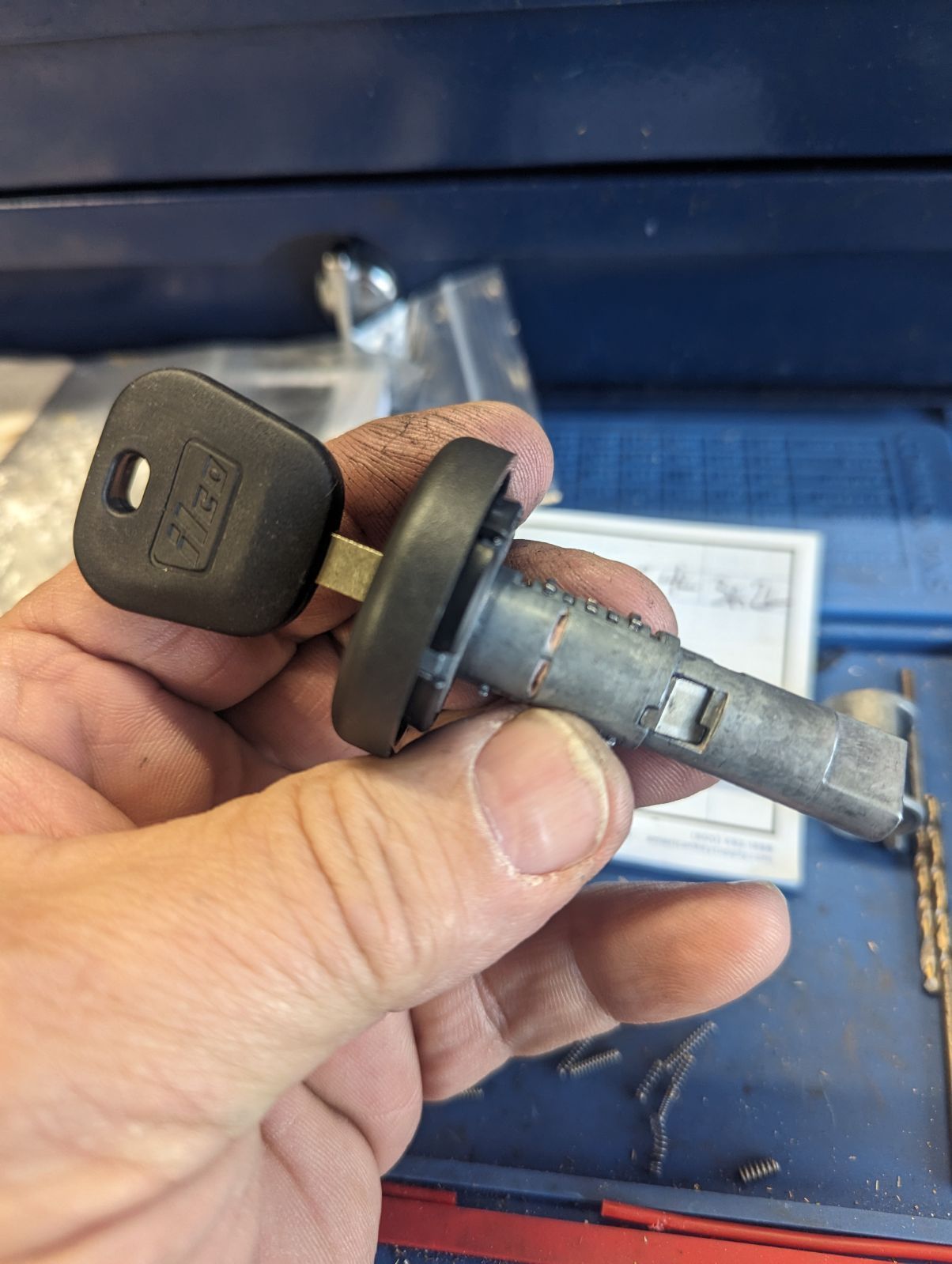 A person is holding a key in their hand.