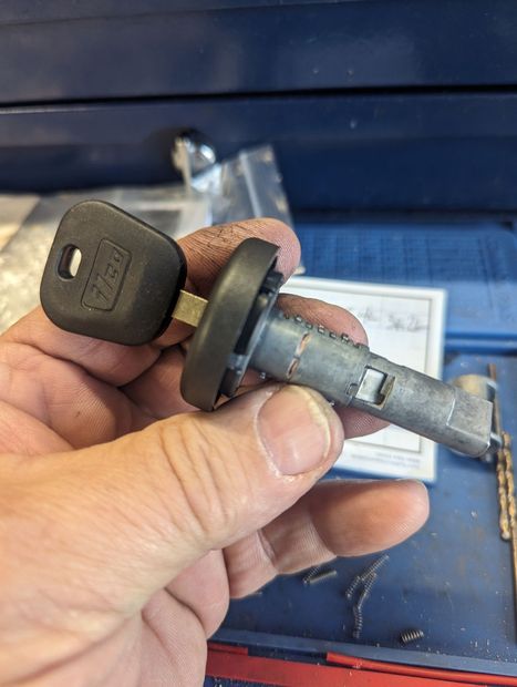 A person is holding a key in their hand.