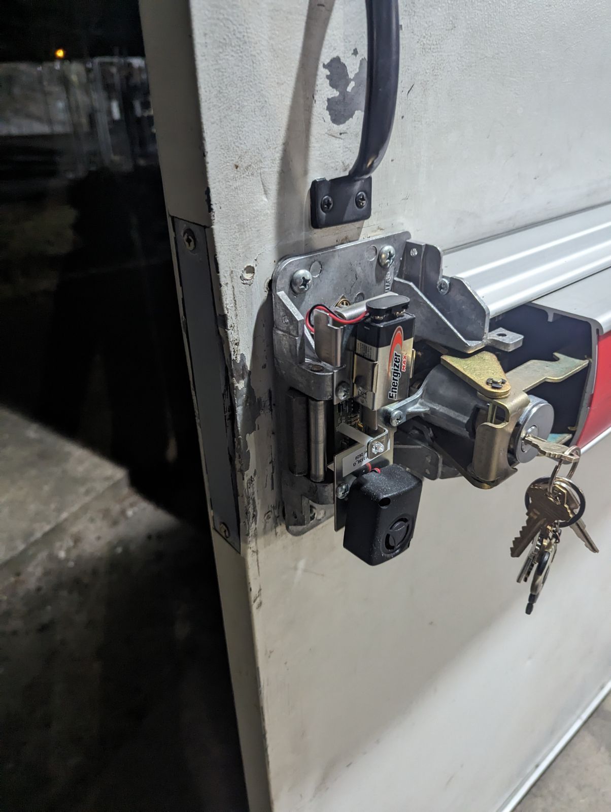 A close up of a door with a lock and keys on it