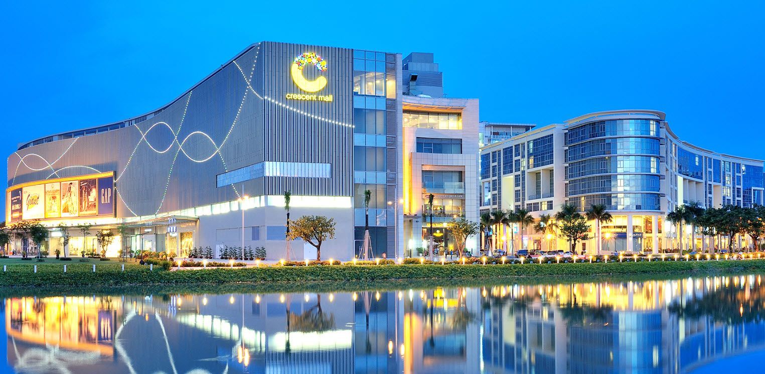 A large building is reflected in a body of water.