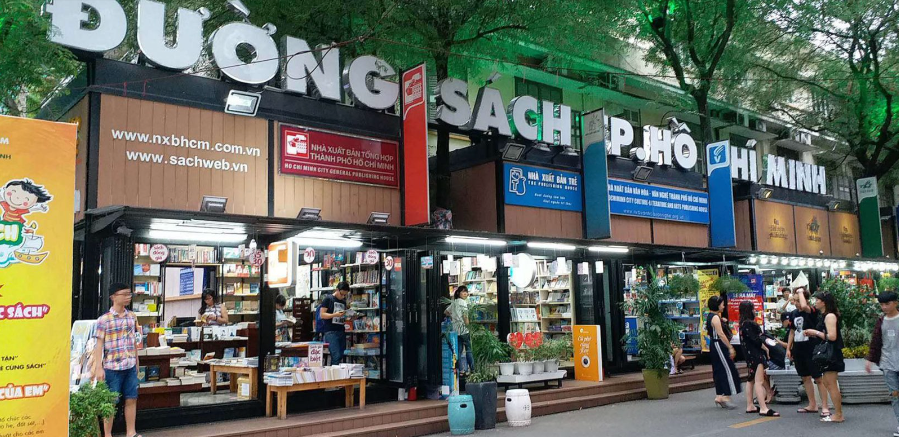 A group of people are standing outside of a bookstore.