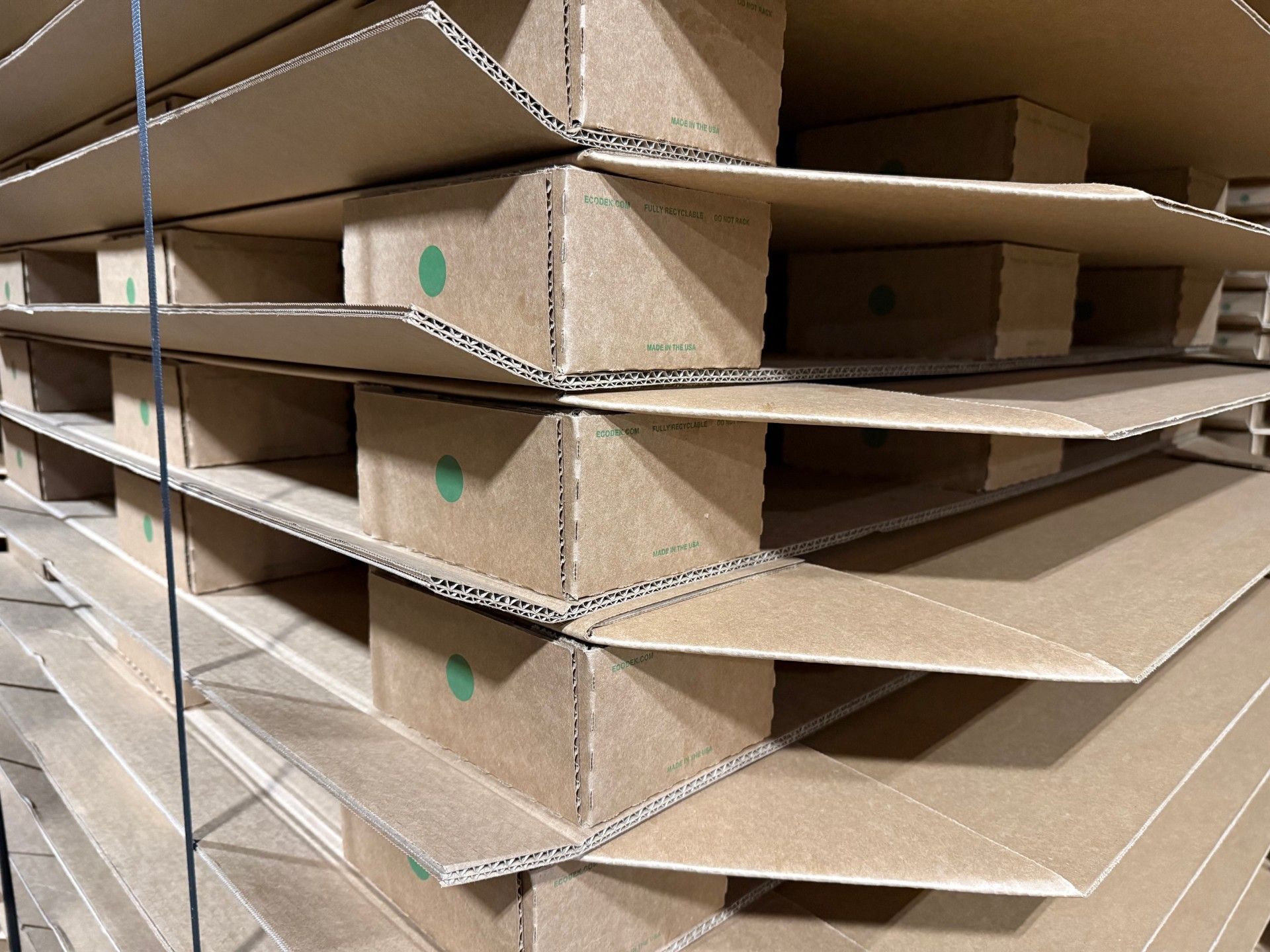 Close-up of corrugated tray pallets showing scored corrugated extensions for push-pull handling.