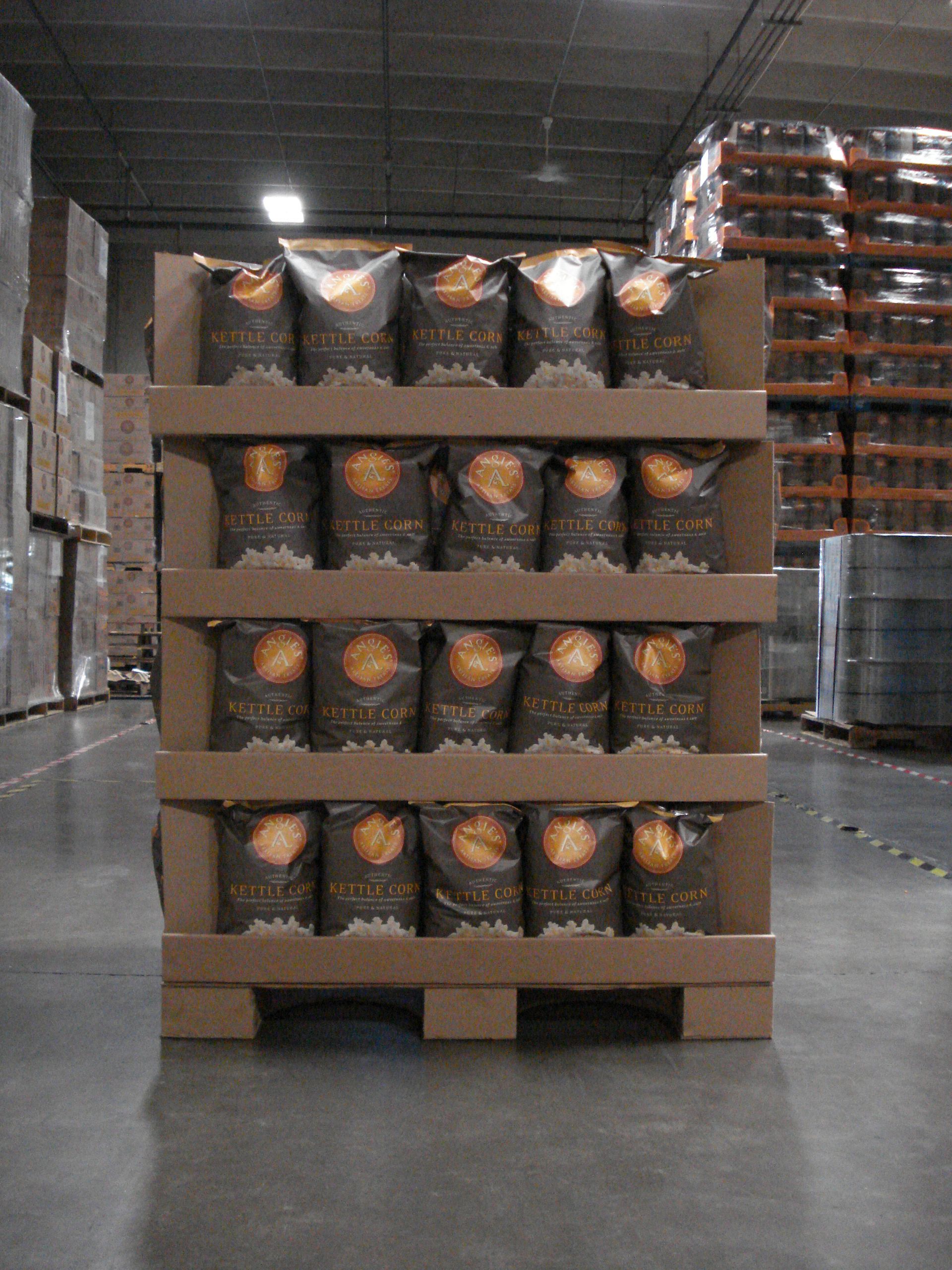 Front view of a multi-tier kettle corn retail display supported by a half-size corrugated pallet with custom-sized blocks.