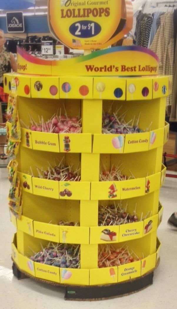 Colorful circular lollipop display supported by a round corrugated pallet in a retail store, eliminating pallet corners.