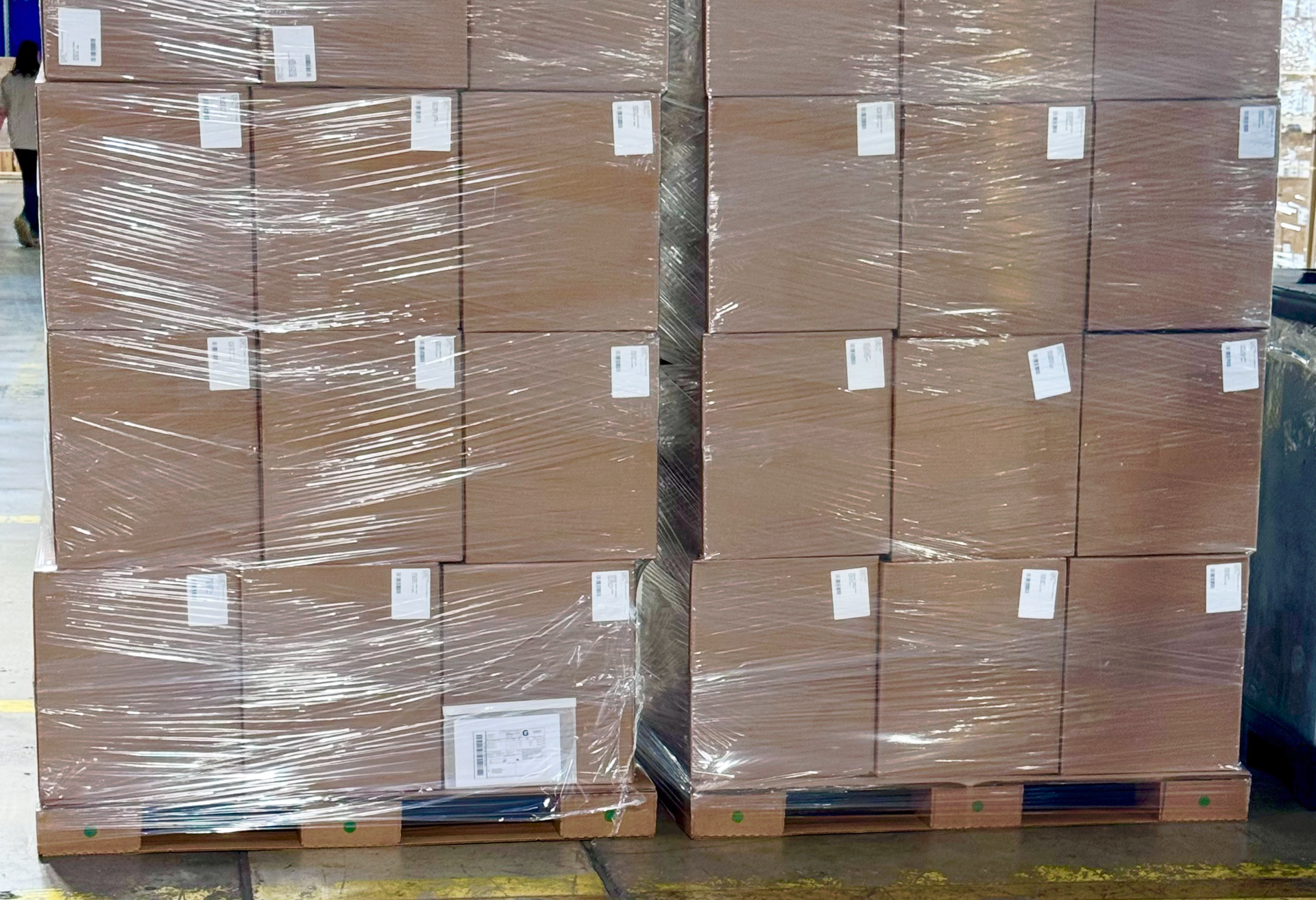 Boxes loaded on a corrugated pallet in a distribution warehouse