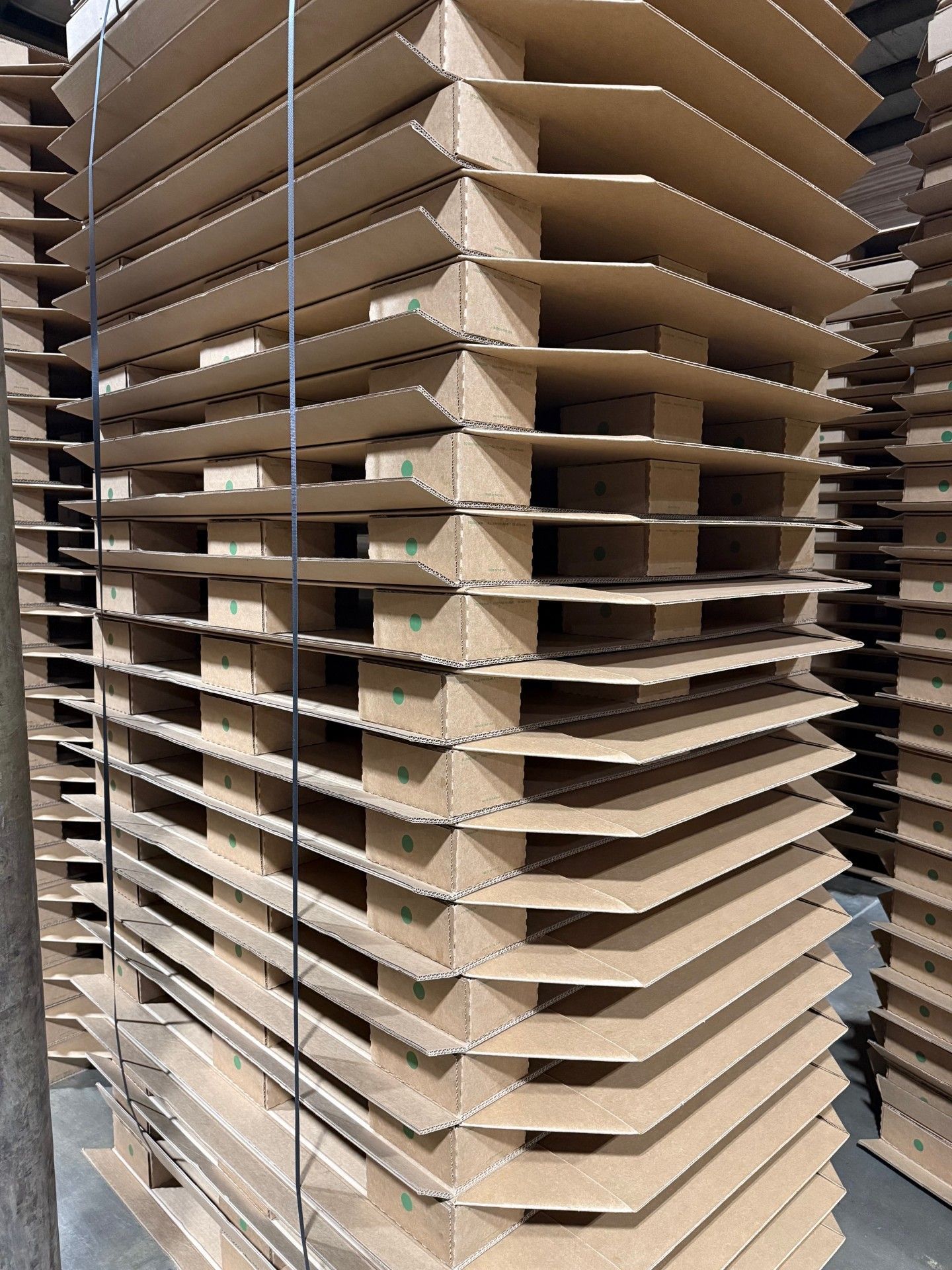 Stacked Ecodek corrugated tray pallets prepared for shipment, showing support blocks and extended corrugated decks.