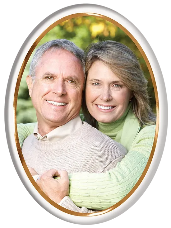Couple embracing and smiling in an oval frame.