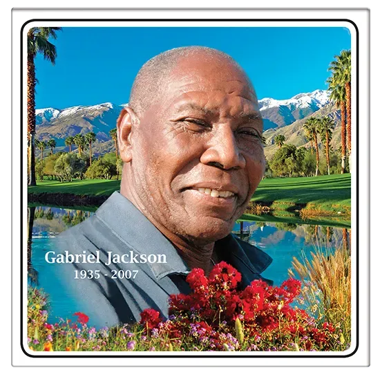 Gabriel Jackson smiling, near a lake, palm trees, and mountains. 1935-2007.