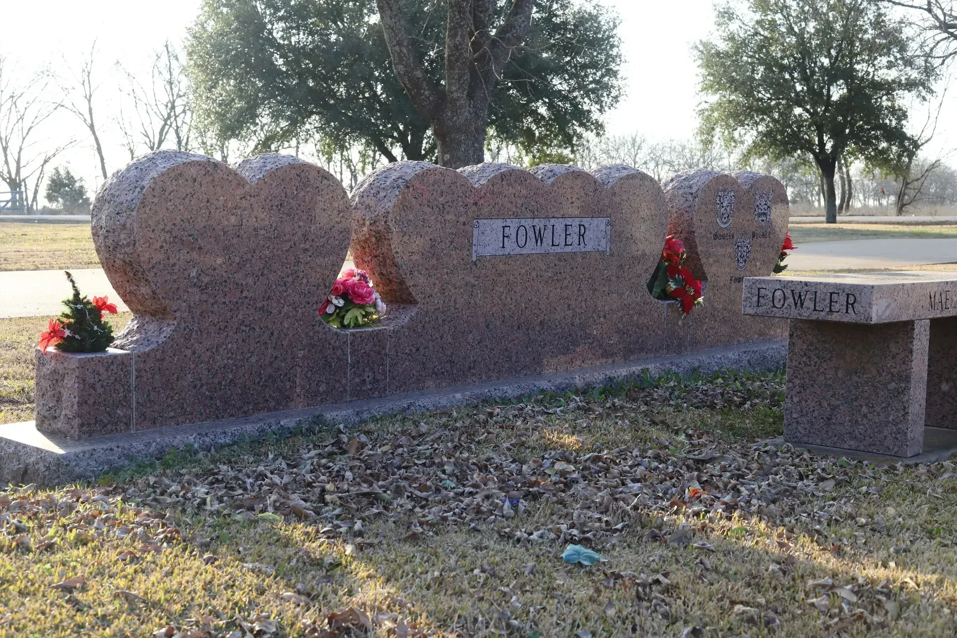 Granite headstones in a cemetery, heart-shaped, with the surname 