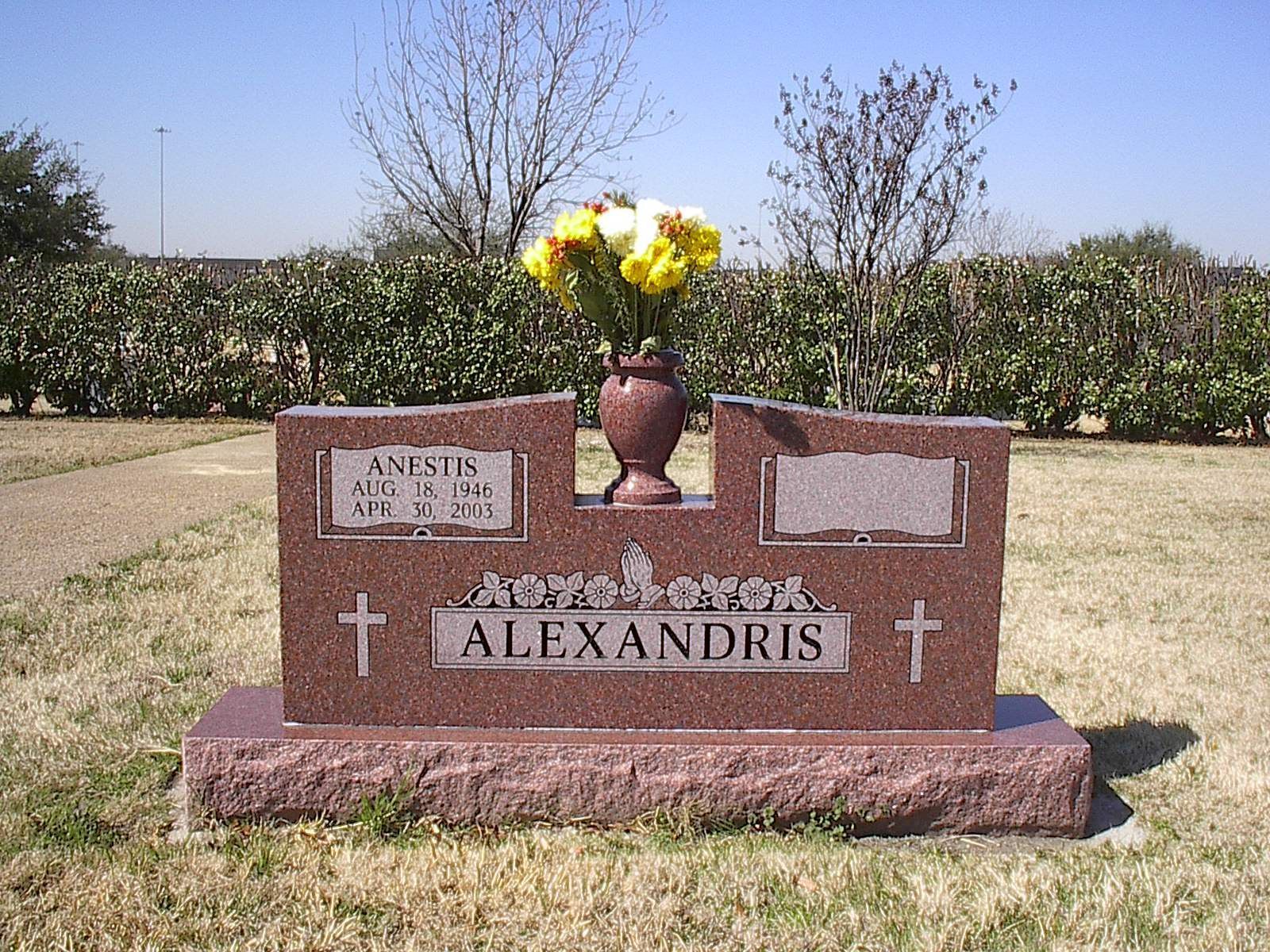 Red granite headstone with flowers, engraved