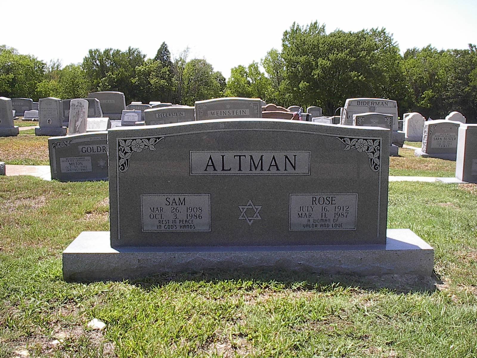 Gray headstone in a cemetery, inscribed