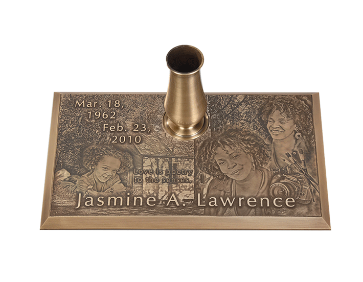 Bronze memorial with vase. Includes etched portraits, dates, and name 