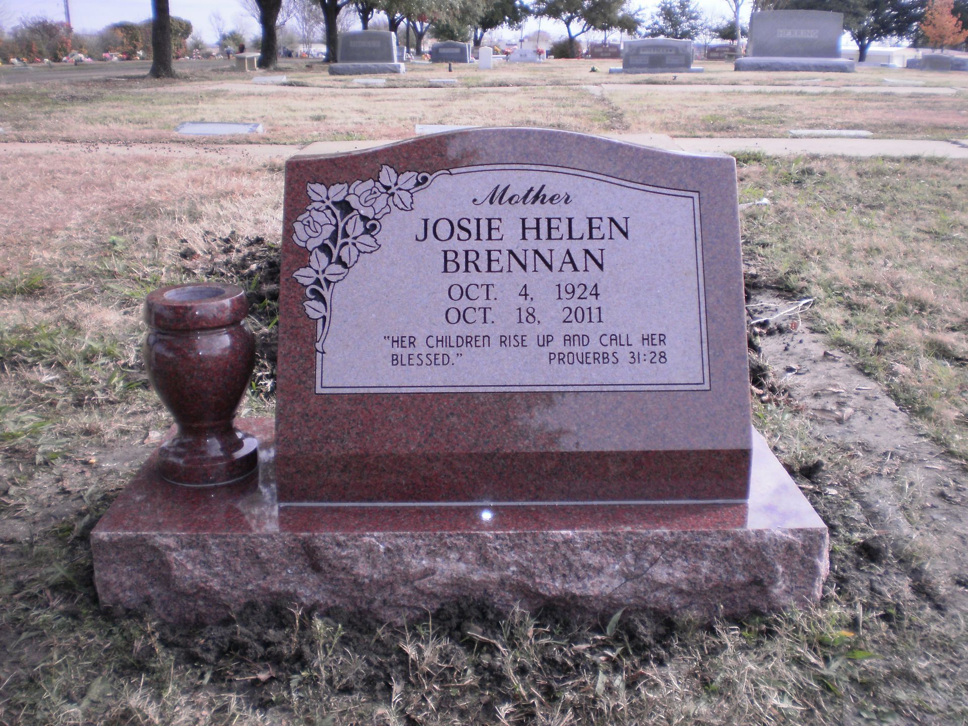 Red granite headstone with inscription