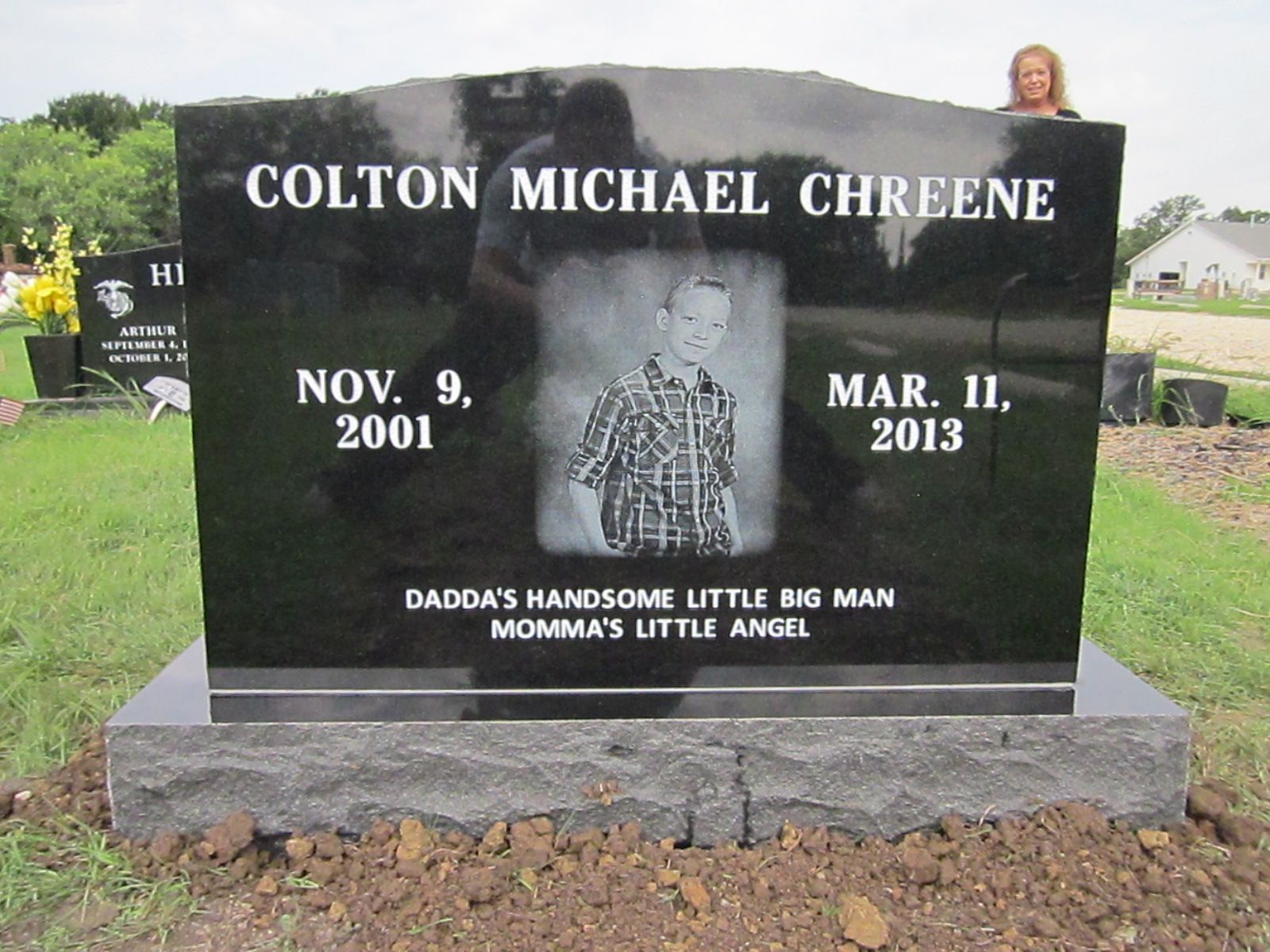 Black headstone with the name
